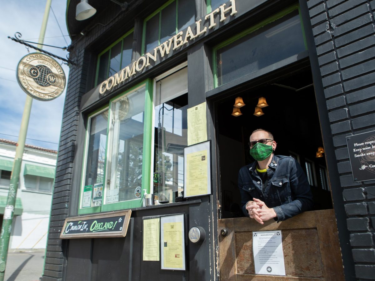 Josh Rosenberg, owner of Commonwealth hangs out of the bar located on Telegraph Avenue.