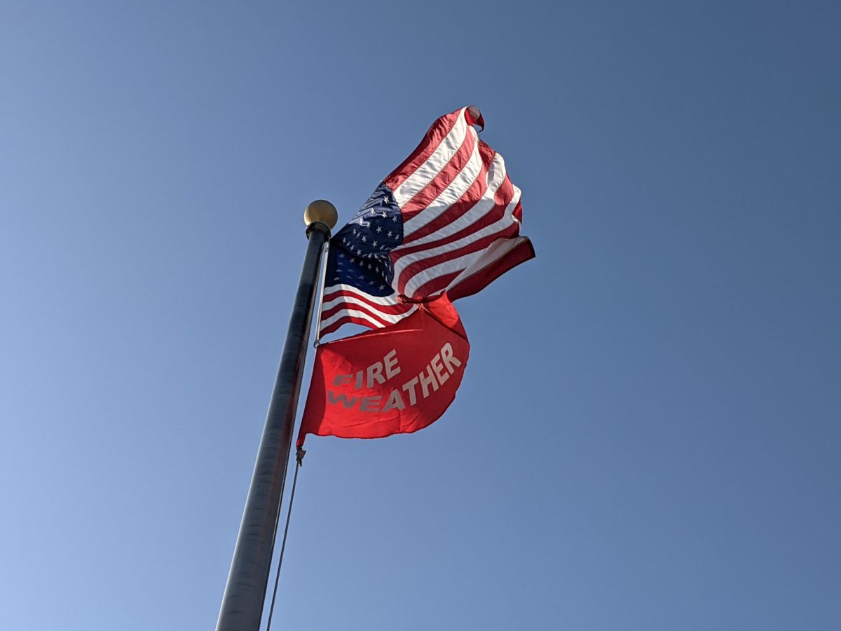 A red flag warning of increased fire danger flies at the Oakland Fire station No. 17 on High Street on Aug. 17, 2021.