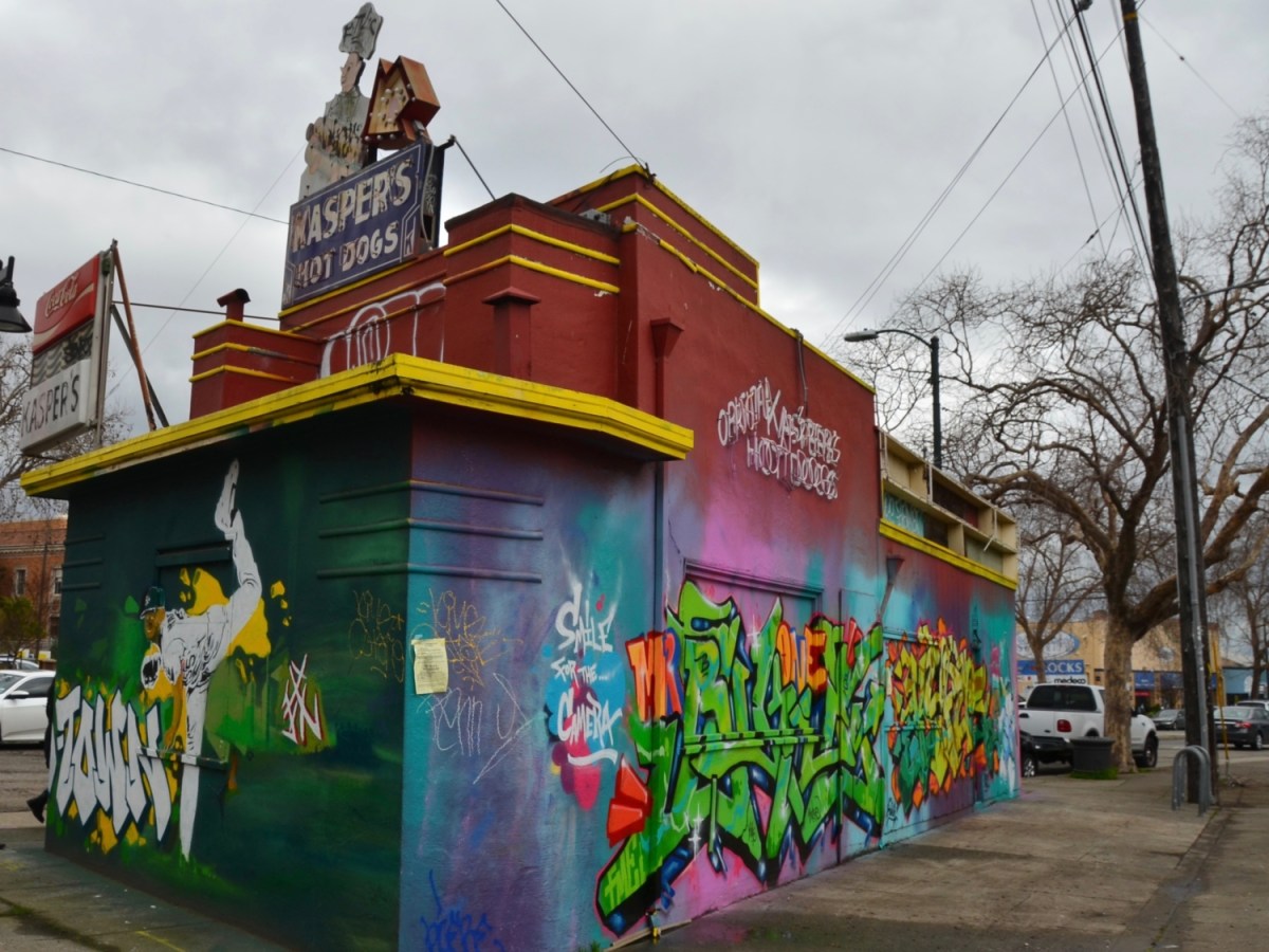 The Kasper's Hot Dogs building in Temescal covered with grafitti and street art.